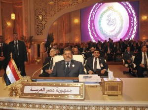 Egypt's President Mohamed Mursi attends during the Arab League summit in Doha