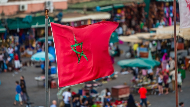 Moroccan flag over Djemaa El Fna Square in Marrakech, Morocco