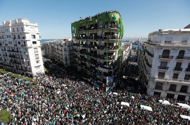 People gather during a protest over President Abdelaziz Bouteflika’s decision to postpone elections and extend his fourth term in office, in Algiers
